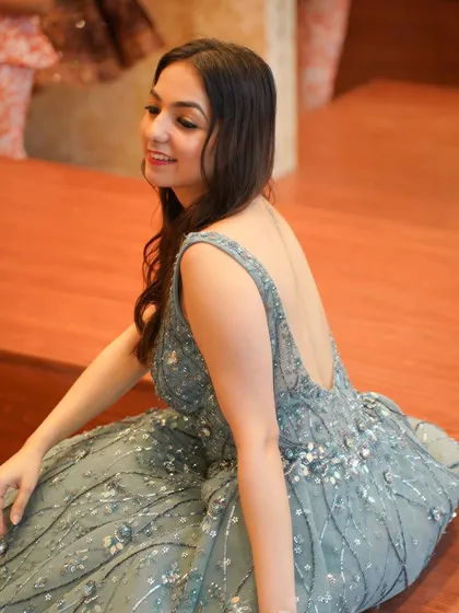 A smiling shot in the grey gown, showing how I bring a joyful and positive energy to my shoots.