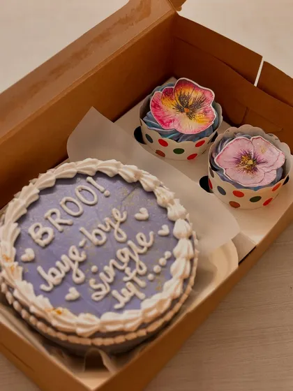 A close-up of the hand-painted floral cupcakes that were part of a groom-to-be's celebration hamper.