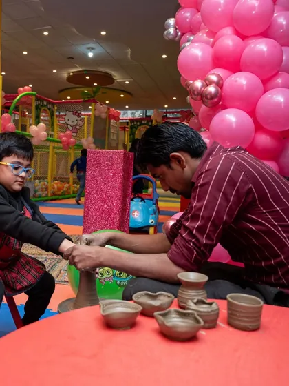 A guest gets hands-on with pottery, guided by an expert. This activity is a fantastic way to engage kids and even adults.