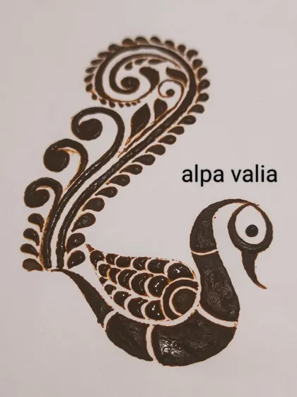 A finished example of a stylized peacock with a beautiful, flowing tail made of paisley and vine patterns.