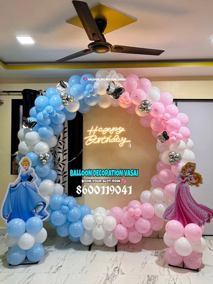 A Cinderella and Sleeping Beauty theme. This ring decoration uses a split-color design with blue and pink balloons to represent both princesses.