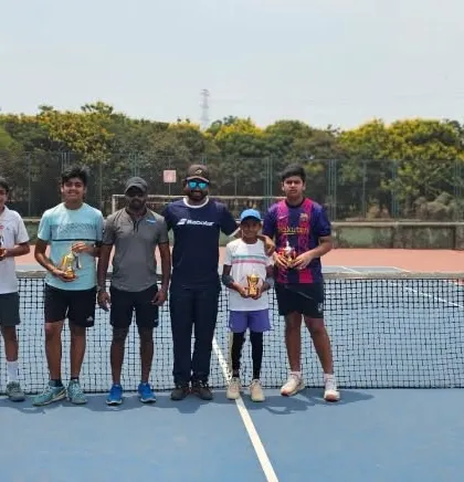 Another group of our tournament winners standing proudly on the court with their trophies.