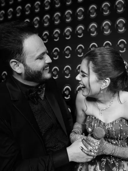 In the quiet moments between the celebrations, true feelings shine. This candid, black and white shot captures the pure, unscripted laughter that we live to document, proving that the most timeless memories are often the simplest.