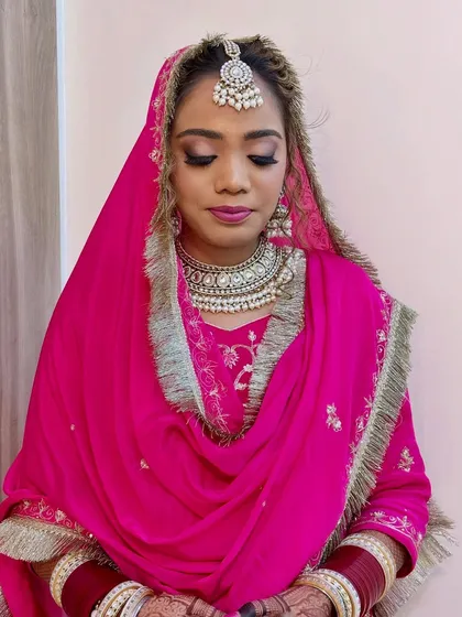 A close-up on the eye makeup for this traditional bridal look. I used a blend of neutral and shimmer shades to make her eyes pop, ensuring the makeup was both beautiful in person and striking in photos.