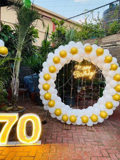Another angle of the white and yellow 70th birthday decoration.