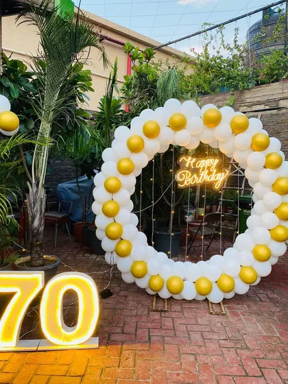 Another angle of the white and yellow 70th birthday decoration.