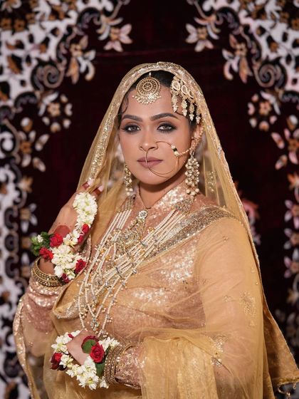 A full view of the bride in her golden attire, adorned with a multi-layered Polki rental set that exudes pure luxury.