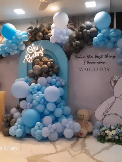 An "Oh Baby" shower setup with hand-drawn style teddy bears and a hot air balloon detail. The mix of blue, black, and white balloons creates a modern and stylish take on the classic teddy bear theme.