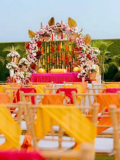 The view from the guest's perspective, looking towards the vibrant Mehendi stage. I ensure that the seating arrangement and decor provide a beautiful and unobstructed view of the main event.