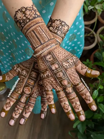 An elegant back-hand design for a baby shower. This mehndi is filled with intricate patterns and includes small, subtle baby-related elements like tiny clothes and toys.