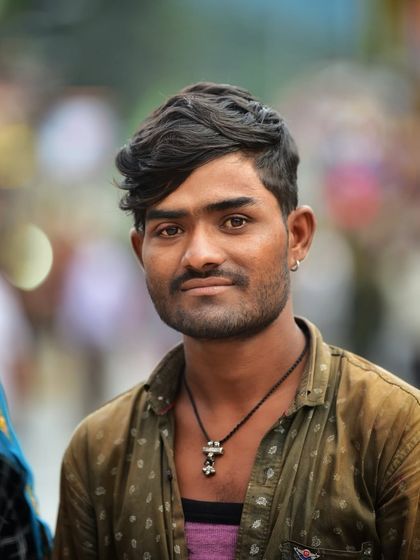 A portrait of a man on the street, capturing his unique features and style. The blurred background keeps the focus on his interesting character.