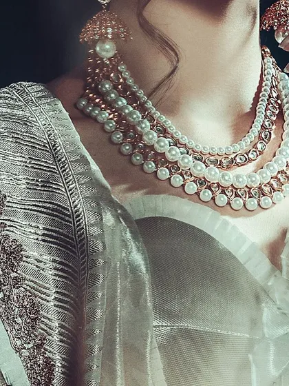 This is a dedicated jewelry shot, tightly cropped to make the multi-layered pearl necklace the absolute hero. This level of detail is perfect for catalogs and brand campaigns where the product's craftsmanship is key.