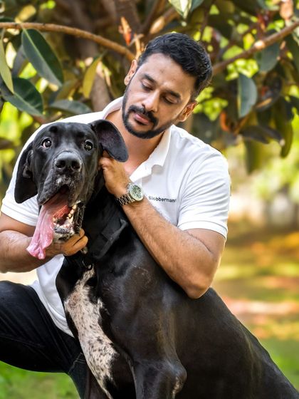 A portrait of a man and his best friend, the Great Dane looking content and happy.