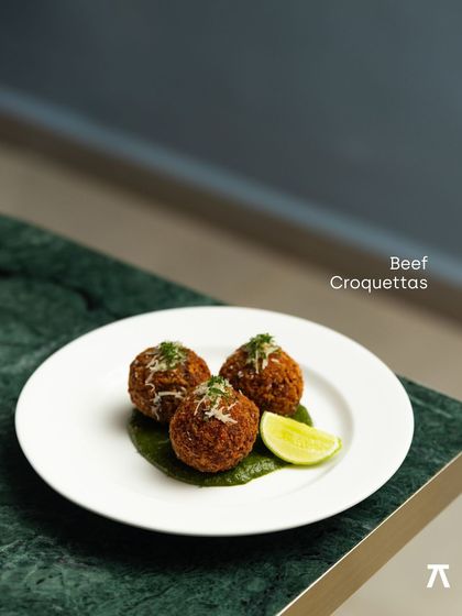 The signature Beef Croquettas from Praça Prazeres, served on a vibrant green marble plate. These were a highlight of the five-course European meal.