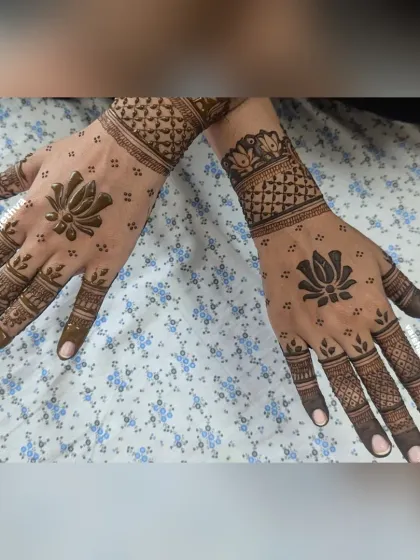 A minimalist design with a modern twist. One hand features a simple lotus motif, while the other has a more detailed cuff, creating a stylishly mismatched look.