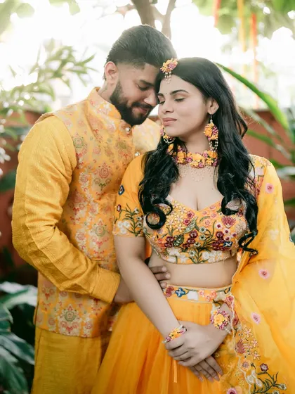 A quiet moment of togetherness amidst the vibrant yellow of the Haldi ceremony.