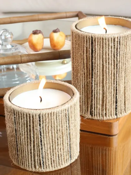 Our jute-wrapped scented candles, shown here on a mirrored tray. The natural texture of the jute provides a beautiful contrast to the reflective surface, creating a balanced and stylish look.