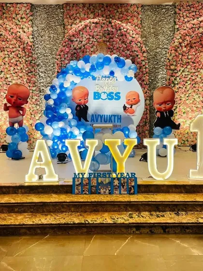 A closer look at the Boss Baby stage, showing the personalized backdrop and a "My First Year" photo display.