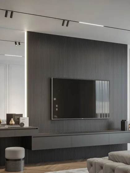 A full view of the TV and vanity wall, showing the seamless integration of function and style. The vertical lighting on the mirror is a practical and glamorous touch.