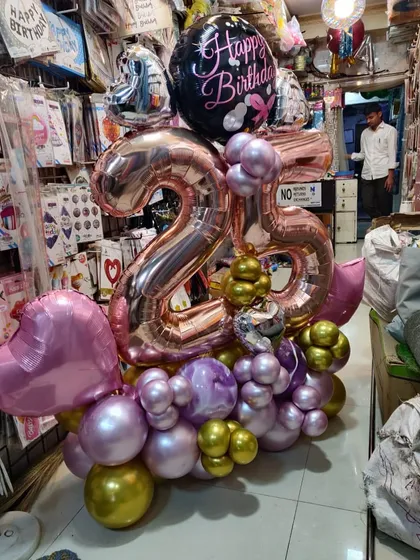 Another look at our elaborate 25th birthday balloon bouquet. This shows how we can combine different shapes, sizes, and colors to create a stunning, multi-layered gift arrangement.