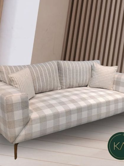 A custom-designed sofa featuring a charming checkered and striped pattern. This piece demonstrates our ability to work with various textiles to create furniture that is playful, stylish, and perfectly suited to a client's personality.