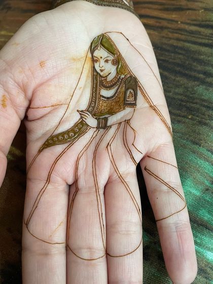 The bride's portrait with the lehenga skirt sketched in, showing how the design extends to cover the fingers.