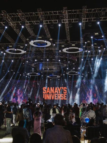 A massive crowd gathers for the main stage performance at 'Sanay's Universe'. The professional lighting rig and large LED screen show the concert-level production I can bring to an event.