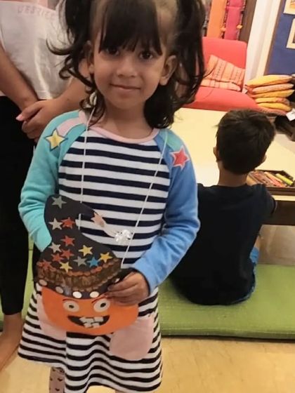 This young artist is ready for Halloween with her custom-decorated goody bag. The kids love being able to add their own creative touches to their crafts.