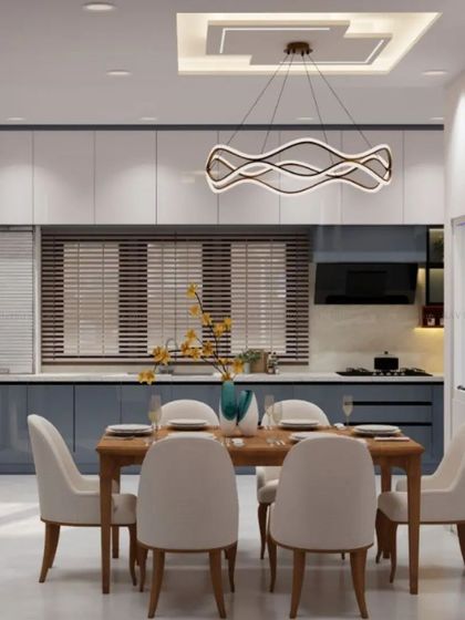 A render of a dining area that opens into a kitchen with two-tone blue and white cabinets. The design is modern, clean, and cohesive.