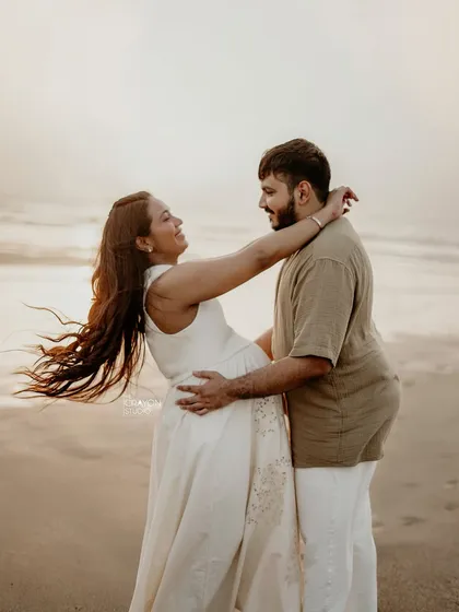 An outdoor maternity shoot on the beach is all about capturing pure, uninhibited joy. I love these moments of laughter and connection, where you can almost feel the sea breeze and the warmth of their love.