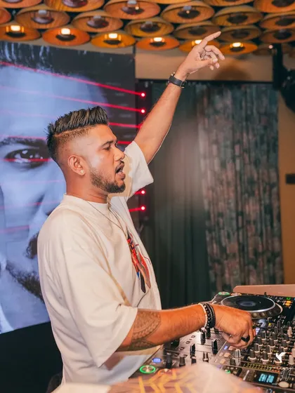 Another angle of me on the mic at Ivoryy, with my custom visuals playing on the screen behind me.