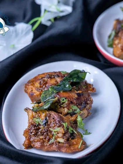 A close-up of my Andhra Grill Chicken, showcasing the rich color from the spices and the fresh garnish of curry leaves. This dish delivers an authentic and powerful flavor punch.
