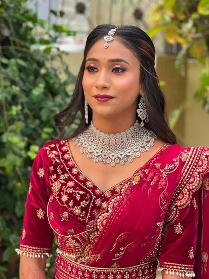 A portrait of the bride looking directly at the camera, showcasing her stunning reception makeup.