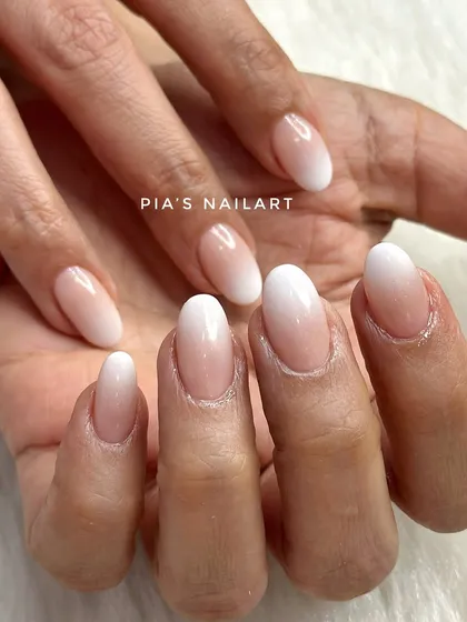 You can never go wrong with a classic. This is my signature baby boomer or soft ombre look, created with a seamless blend from a milky nude to a soft white tip. It's the definition of timeless elegance.
