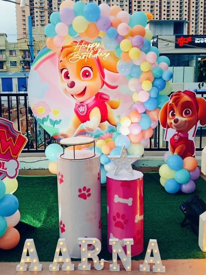 A Paw Patrol themed party with a focus on the character Skye, set up on a rooftop with an artificial grass floor.