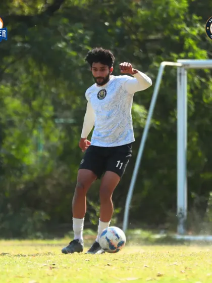 A player in full stride, controlling the ball and looking to make a decisive play.