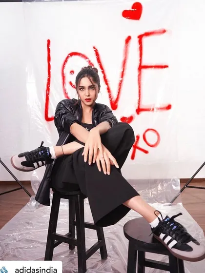 A shot from the Adidas 'Club Originals' campaign with Sharvari Wagh. This look is all about attitude, with a messy top knot, a bold red lip, and sharp eyes to convey a sense of creative energy.