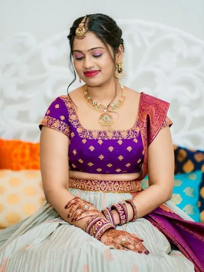 A stunning portrait of the bride, her intricate henna and beautiful jewelry perfectly complementing her custom lehenga.