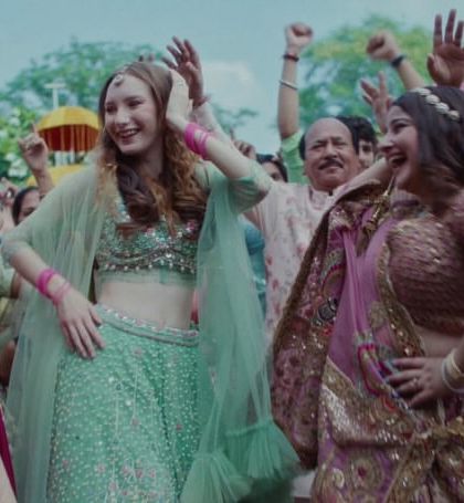 The bride dancing with her friends, showcasing the different festive outfits I curated, including a stunning mint green lehenga for the bridesmaid.
