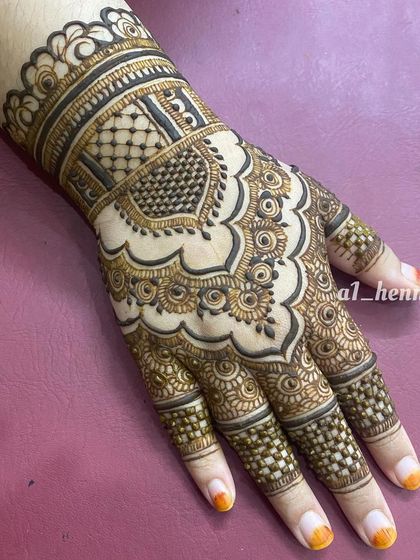 A close-up of a single hand with a beautiful, intricate party design.