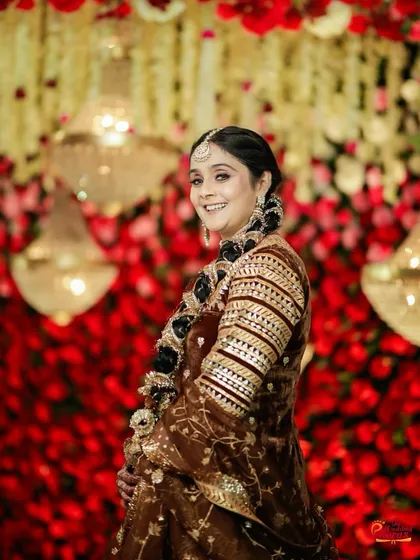 A side profile capturing the intricate hairstyle and the elegant makeup. The look was crafted to be beautiful from every angle, ensuring she felt confident throughout her special day.