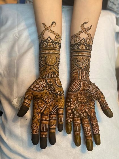 Both hands together, showing the complete and complementary designs for the bride.