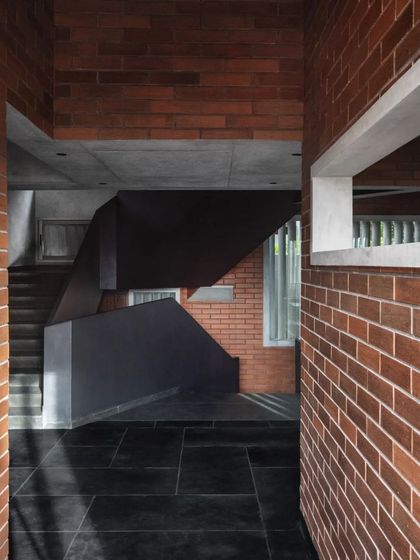 A view from a doorway in the Brick House, looking towards the central staircase, reveals the layered and interconnected nature of the interior spaces.