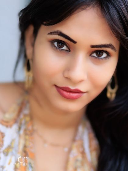 An intimate and captivating close-up. The focus is entirely on her expressive eyes and gentle smile.