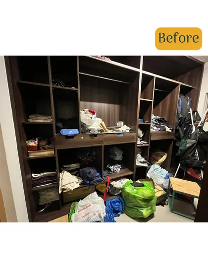 This is another view of the walk-in closet before we started. Bags, clothes, and other items were left on the floor, creating a chaotic environment.