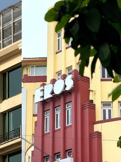 The iconic 'Eros' cinema sign, a landmark of Mumbai's Art Deco heritage, captured in a layered composition.