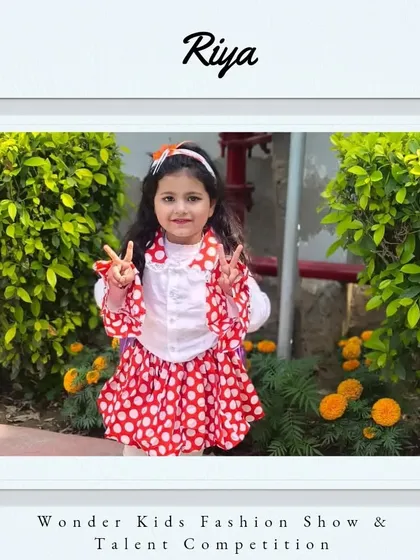 Welcome to the show, Riya. Her polka-dot outfit and peace signs are super cute and fun.