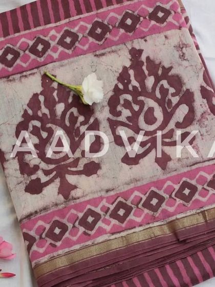 This beautiful pink and brown batik print on a silk cotton base is perfect for summer. The golden zari border adds a touch of festive grace.