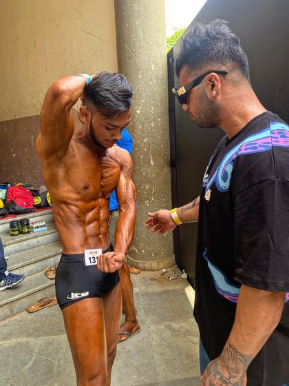 Final checks on conditioning and posing before the ICN championship. This is where we ensure the physique is presented at its absolute peak.