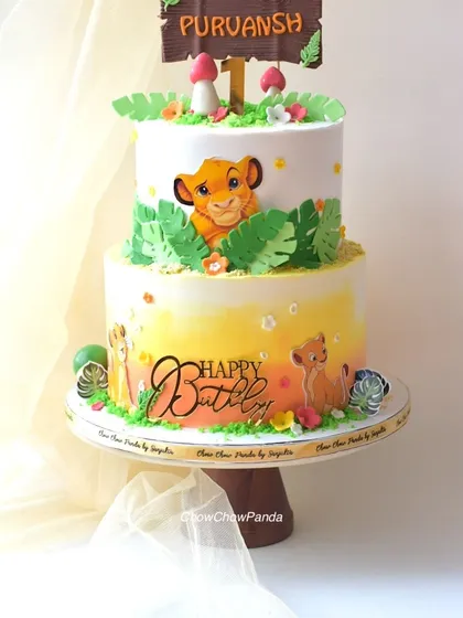 I brought the Pride Lands to life with this two-tier Lion King birthday cake. It features a warm sunset-coloured buttercream ombre, edible images of Simba, and jungle-themed details like leaves and mushrooms, making it a great centrepiece for a jungle party.